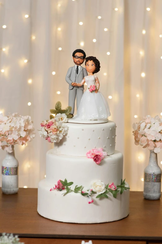 a cake decorated with flowers and a couple