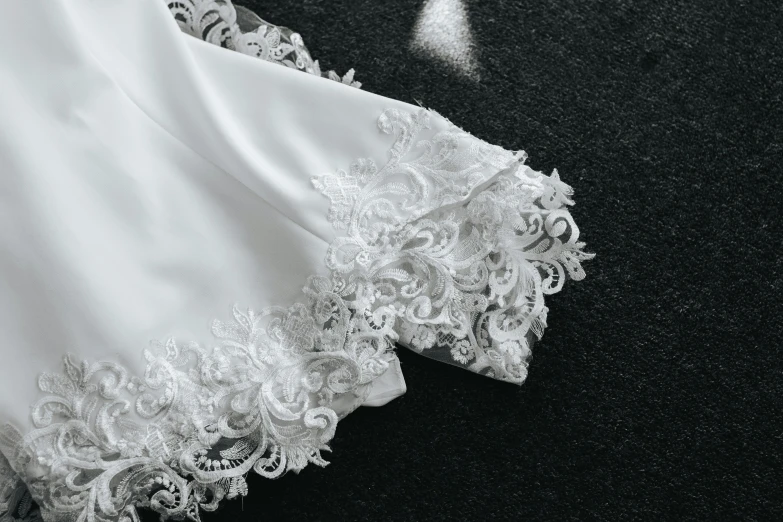 a white blouse with an embroidered lace edge