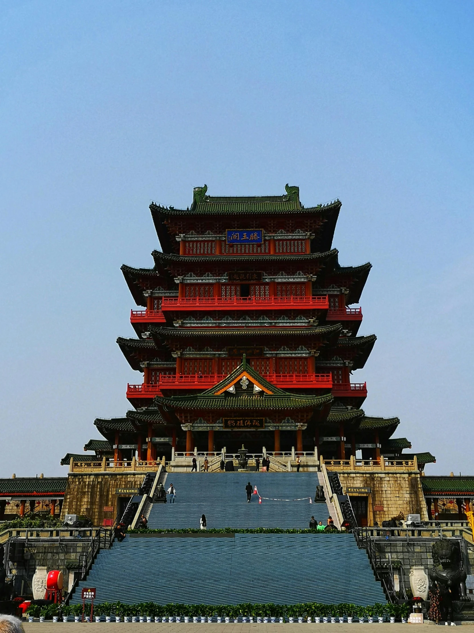 a tall asian style tower sitting in the middle of a street