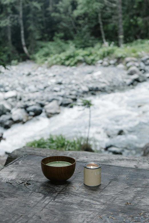 a candle on a table near a river