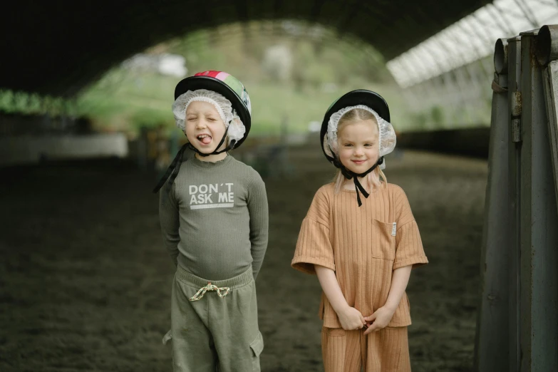 two young children with hats pose for a picture