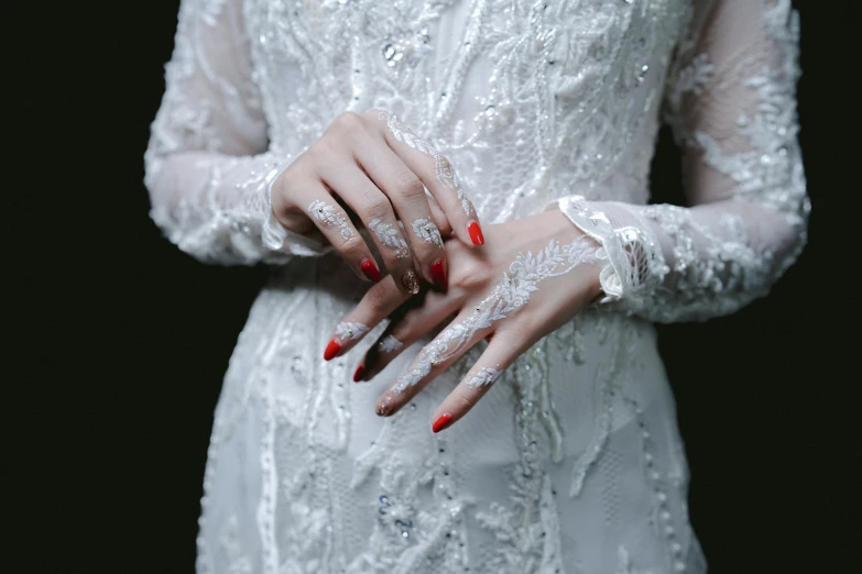 a woman wearing a dress and lace celet