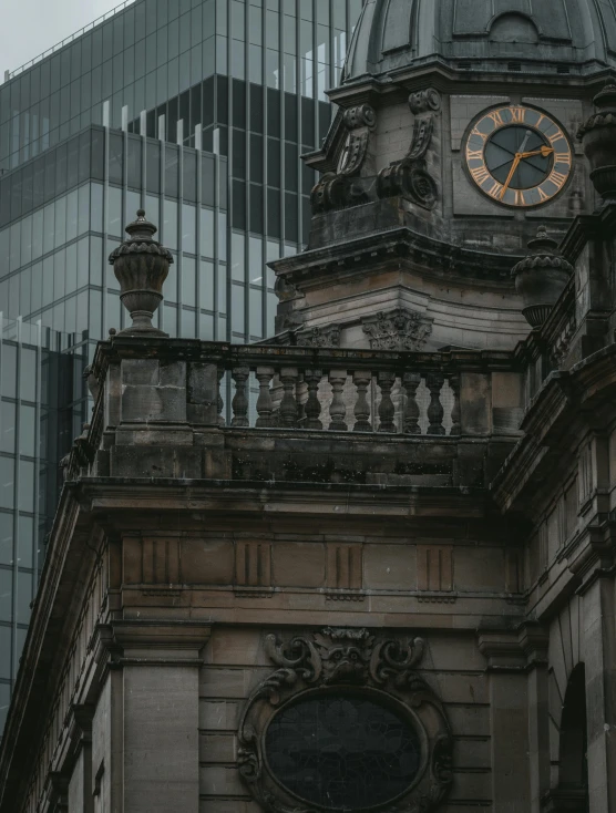 a stone building with a very big clock on top