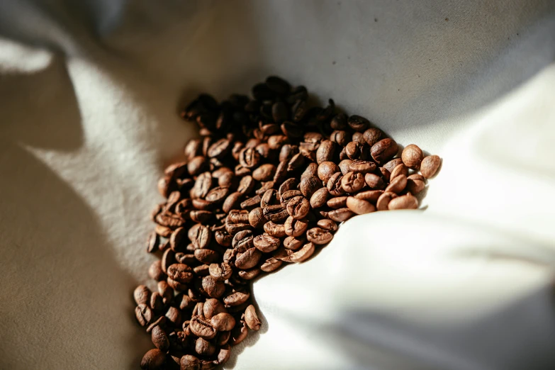 a pile of coffee beans that have been placed in the shape of a heart