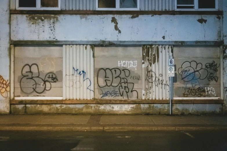 a door is open in front of a building with some graffiti on it