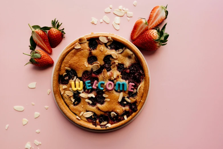 a bowl with strawberries and a blueberry pie on it