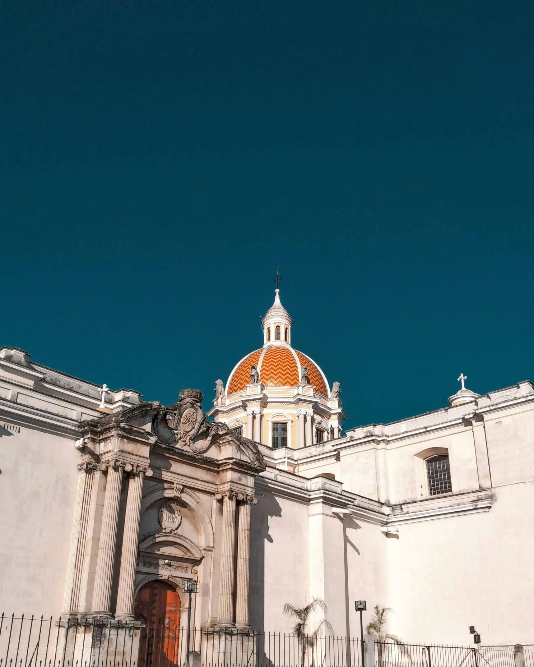 the facade of a building with two orange domes