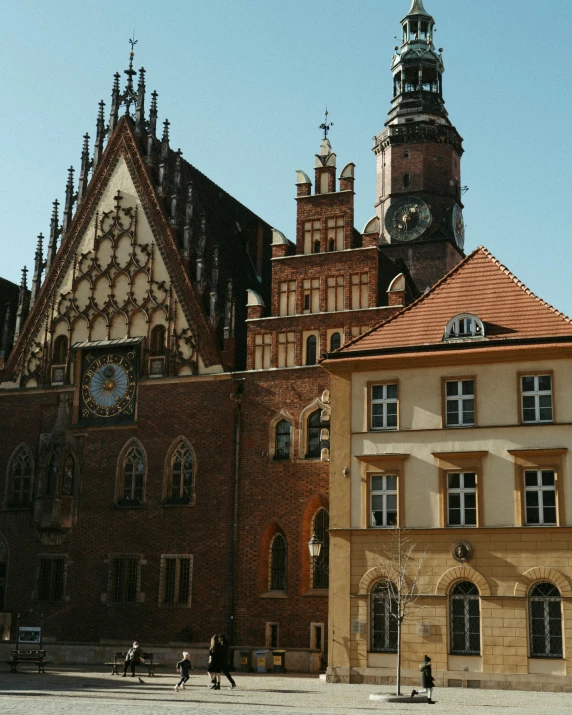 a tall brown building with a clock on the top