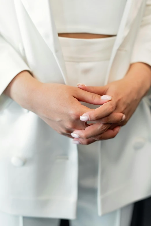 closeup view of a bride's white nails