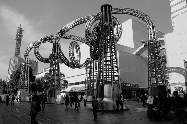 people walking around in front of some very tall buildings