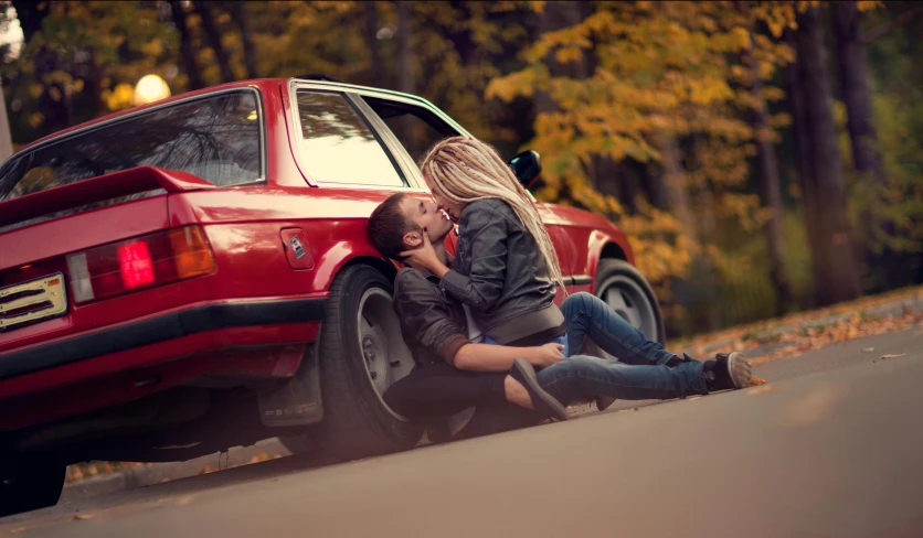 there is a woman sitting on the ground next to a man