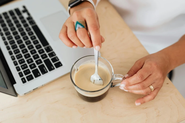 someone using a cup of coffee for a smoothie