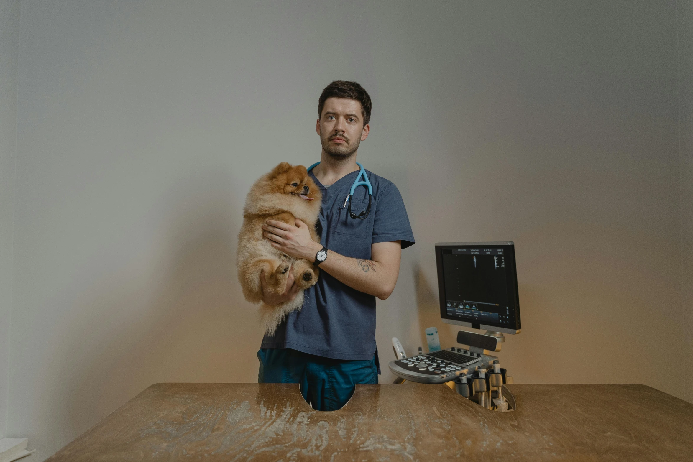 the vet is standing with his brown dog