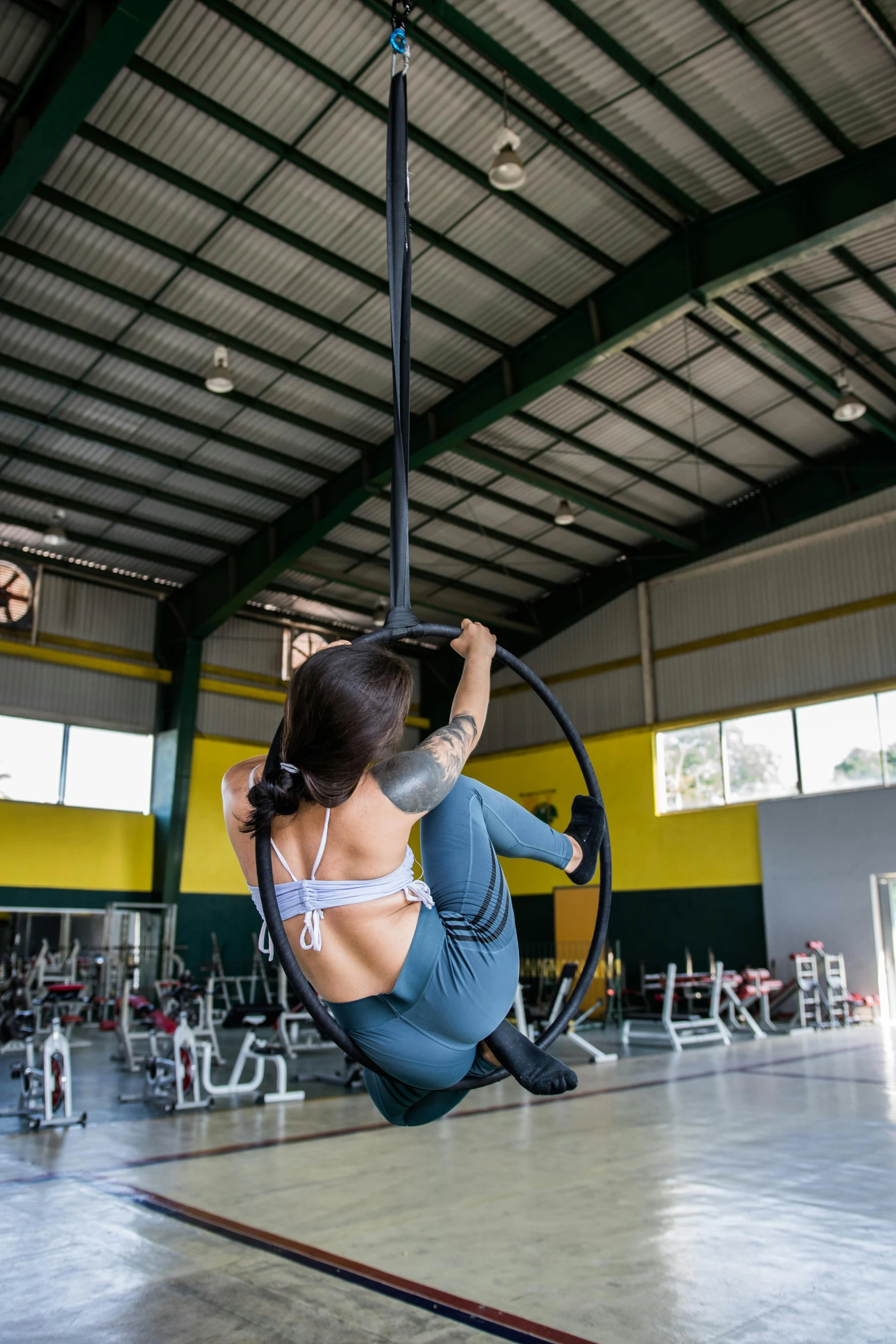 a beautiful woman in grey sitting on top of a hoop