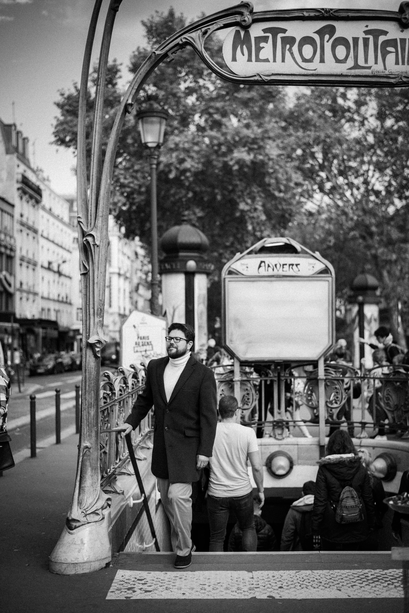 a man standing at the end of a platform holding a sign