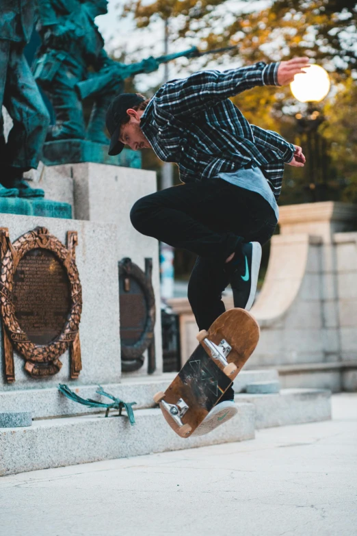 a boy doing a trick on a skateboard