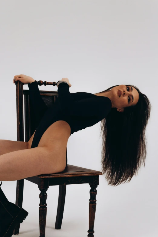 a female with long hair laying down on a chair