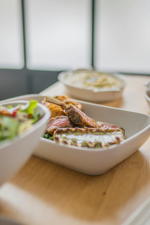 three dishes of food sit on top of a table