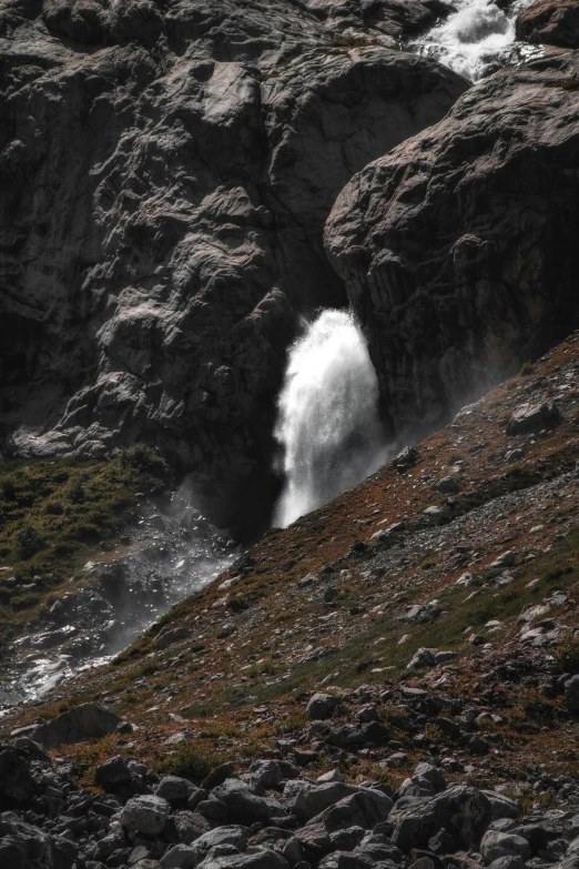 a large waterfall in the middle of a mountain