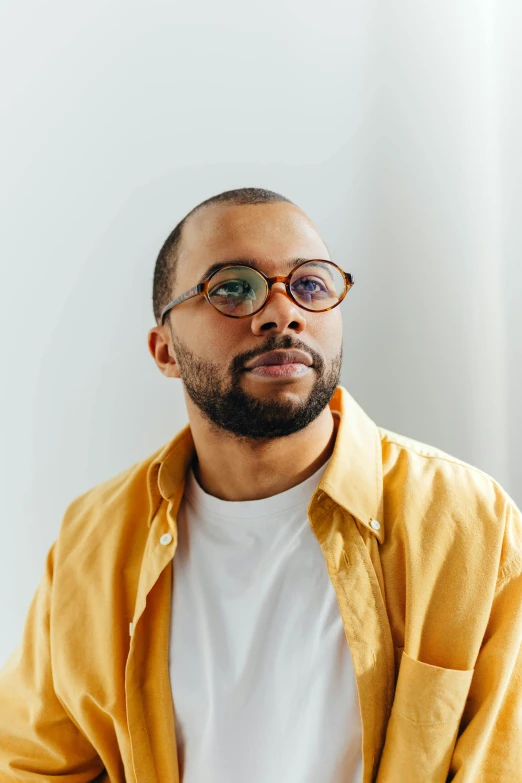 a black man wearing yellow and orange glasses