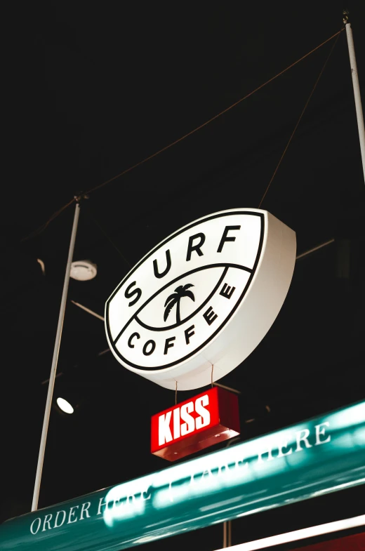 the neon sign for surf cafe in white lights