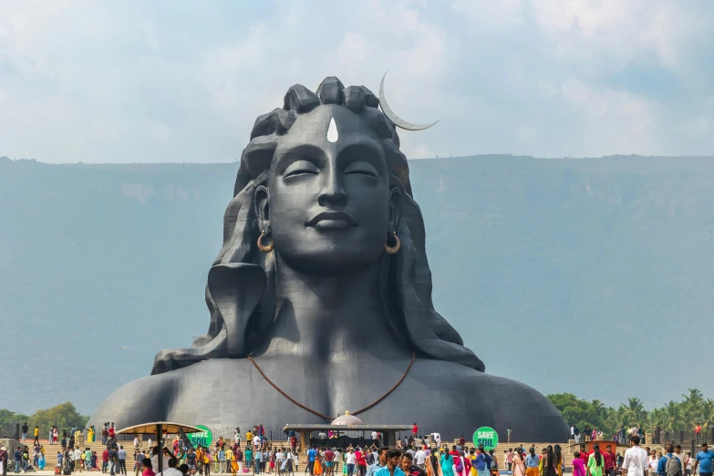 a large statue with several people around it