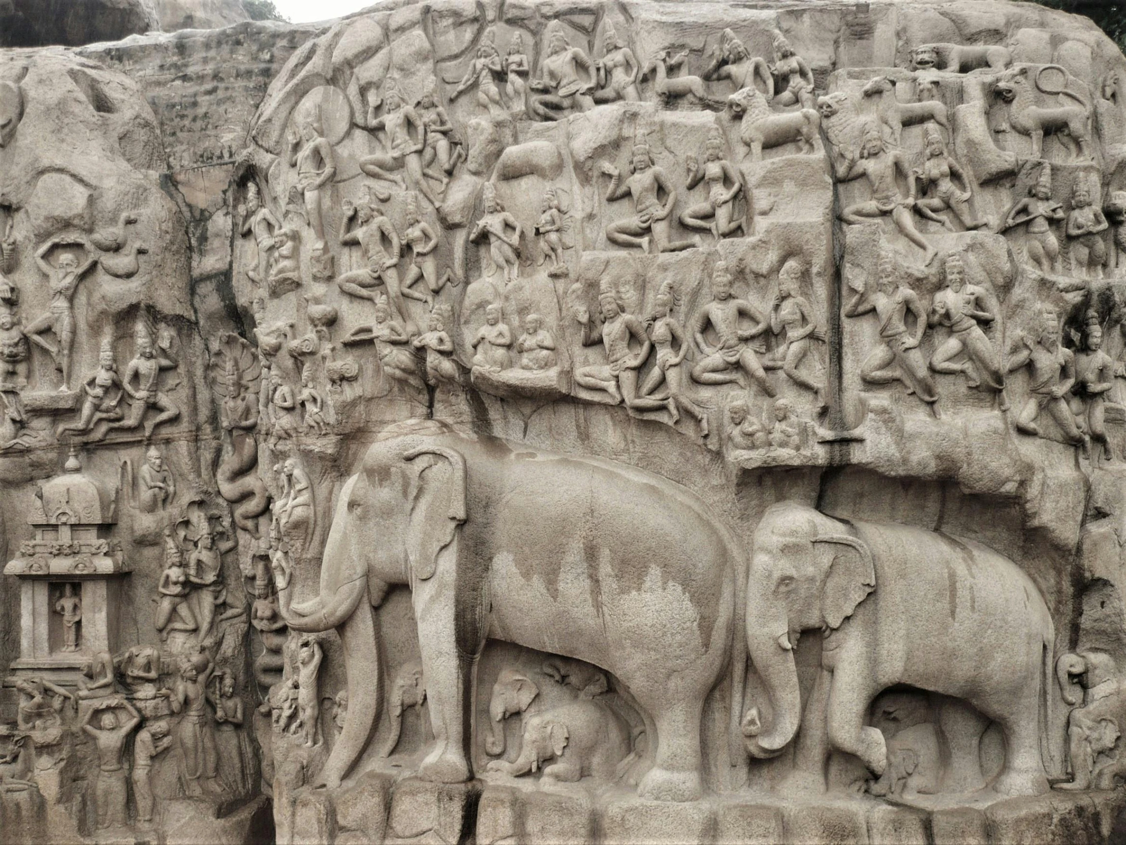 several elephants in ancient carvings are on a stone wall