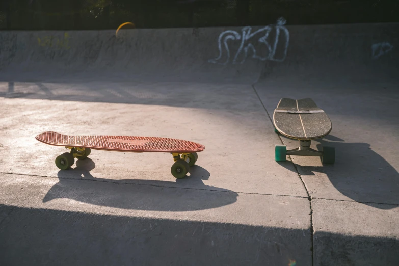 skateboards sit in the concrete of a skate park