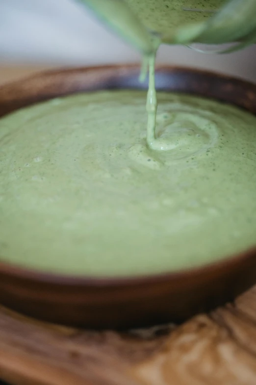 a pot with green liquid is sitting on the table