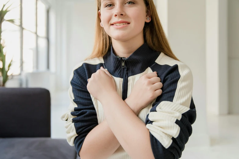 a girl in a jacket and pants posing for a po