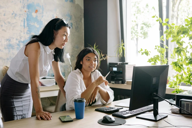 two women working in an office at a desk