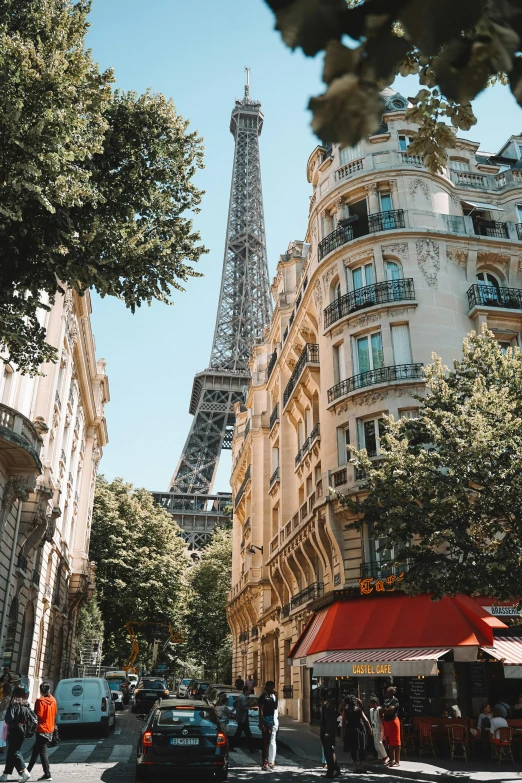 a group of cars parked in front of the eiffel tower