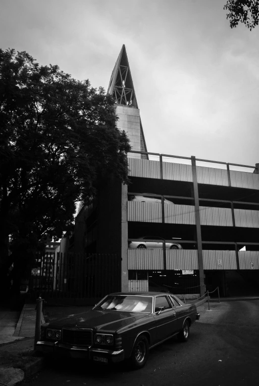 there is a black car parked outside a building