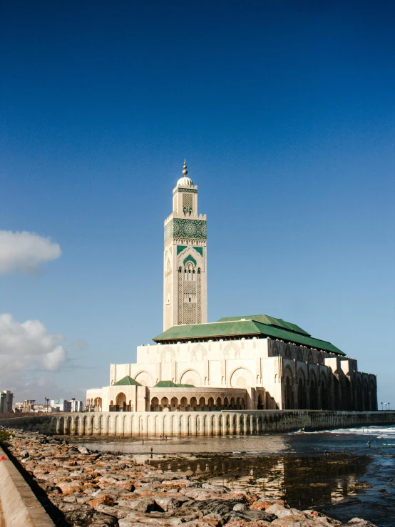 a tall building near the ocean with a clock on it