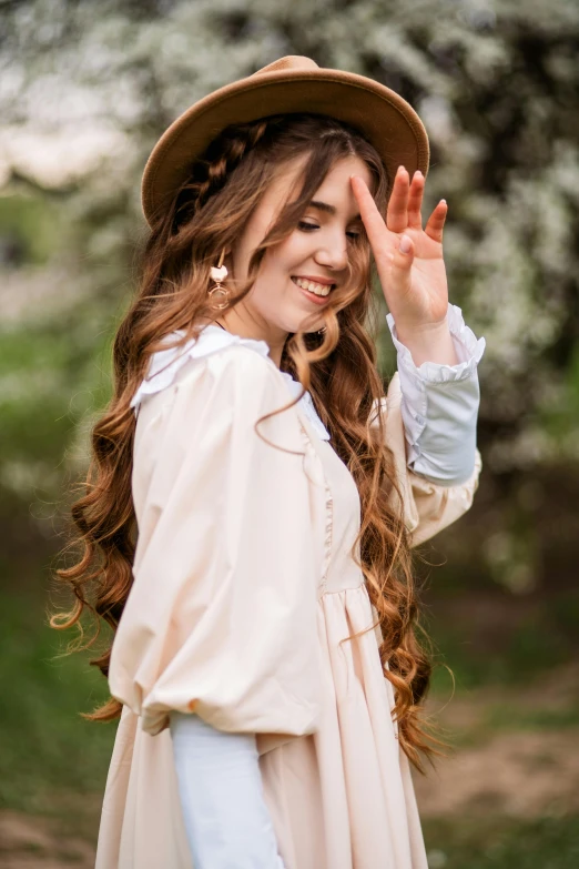 a young woman holding her hand up in the air