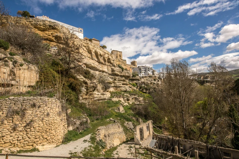 a dirt path that goes up the side of a rocky hill