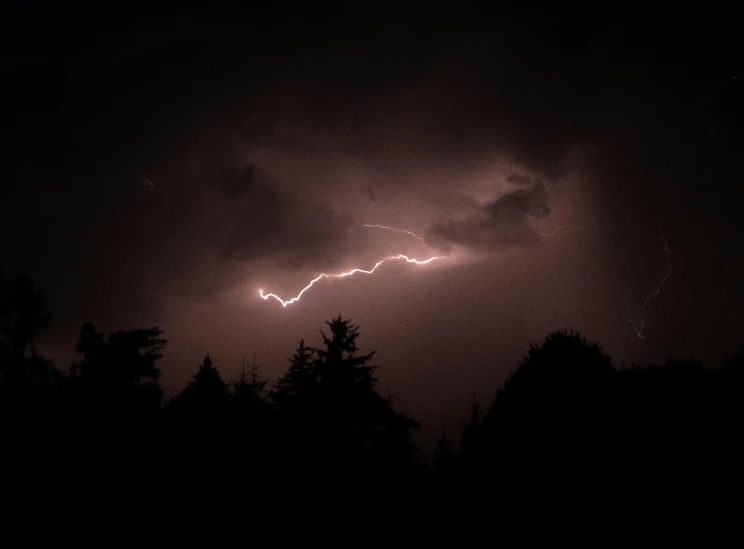 a lightning is seen on a cloudy night