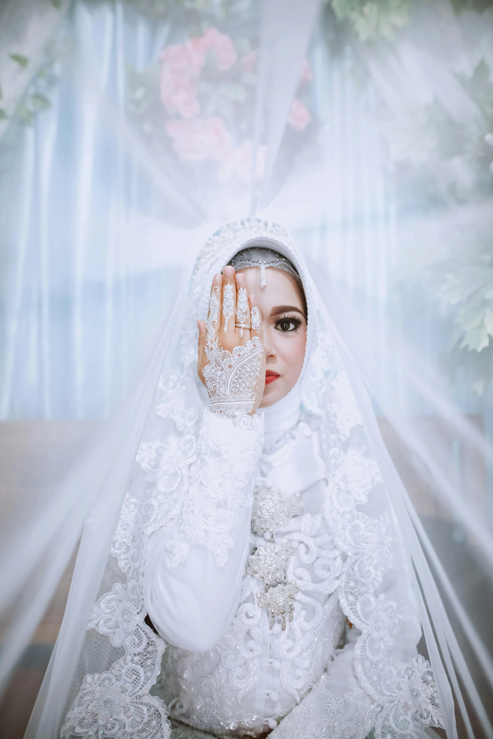 a woman with white hands dressed in white