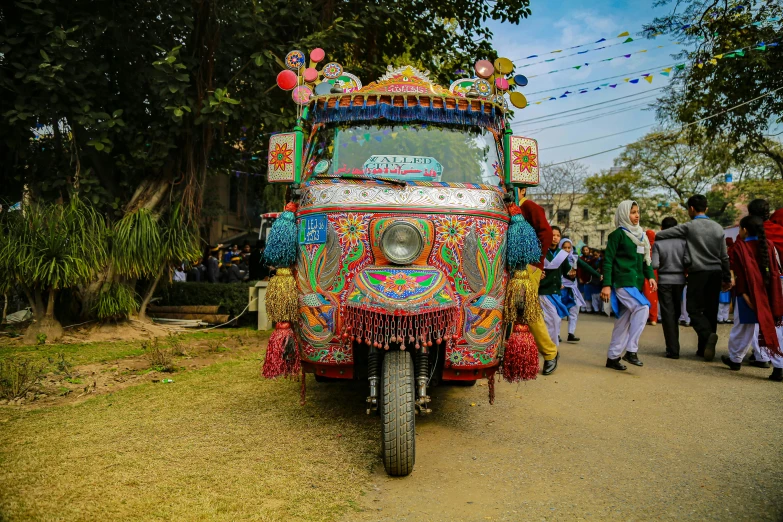 a brightly decorated truck is going down a small road