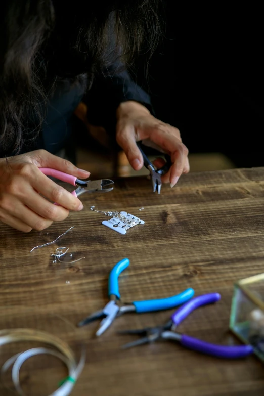 someone using scissors to trim some paper with scissors