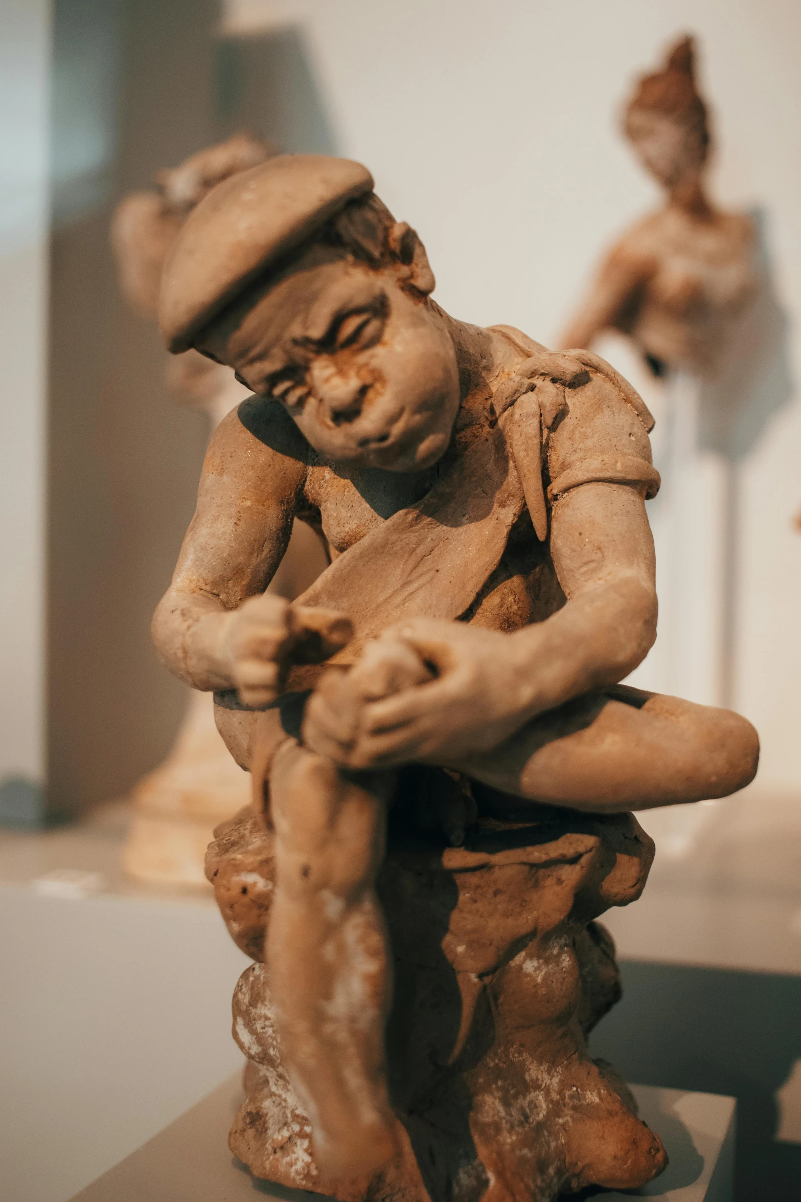 a statue of a child with a hat on it's head