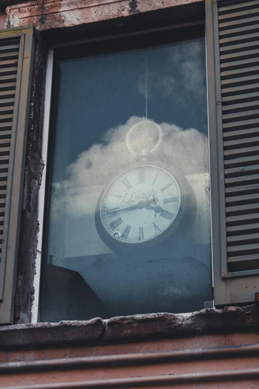 an image of a clock with clouds in the back