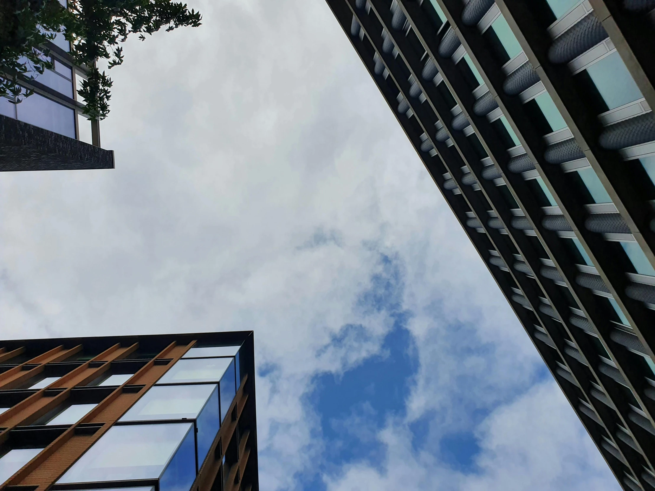 view looking up at building and cloudy sky