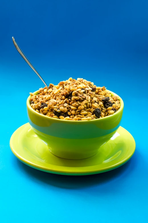 blueberry granola sits atop an apple green dish
