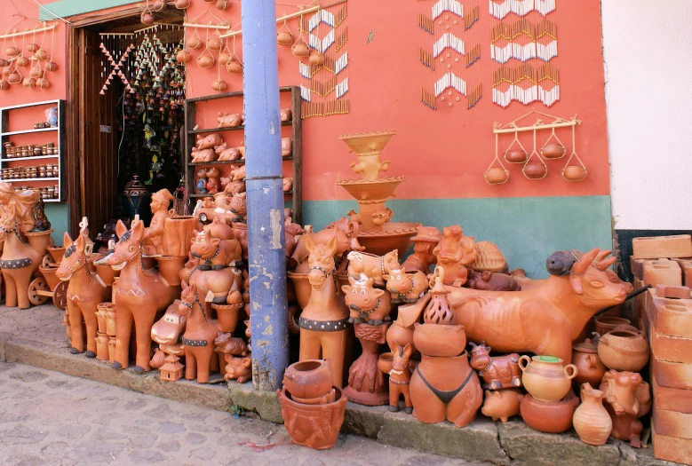 a variety of pottery on display outside of a shop