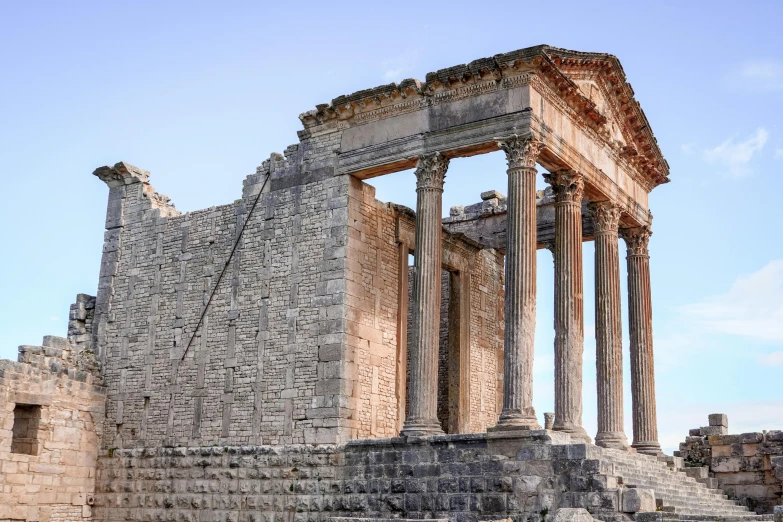 a row of pillars sitting in the ruins of a building