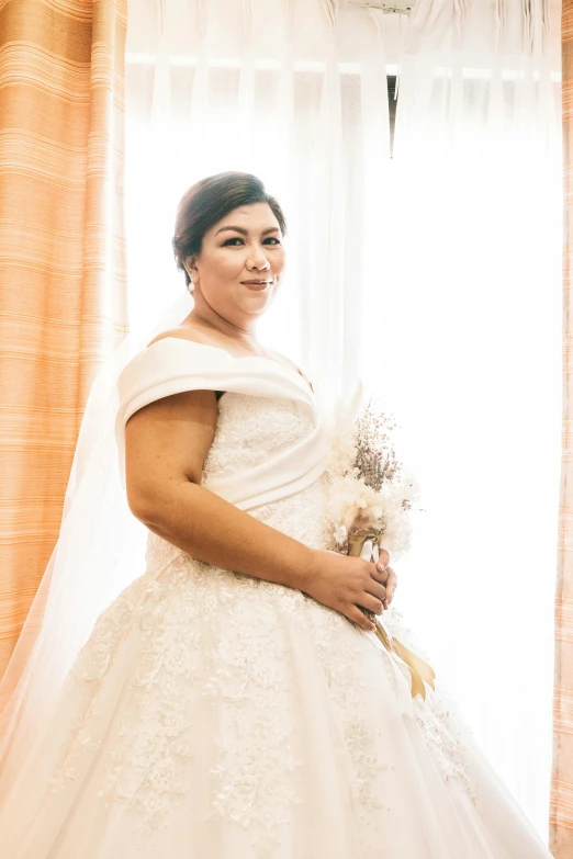 woman in large white wedding dress posing for a picture