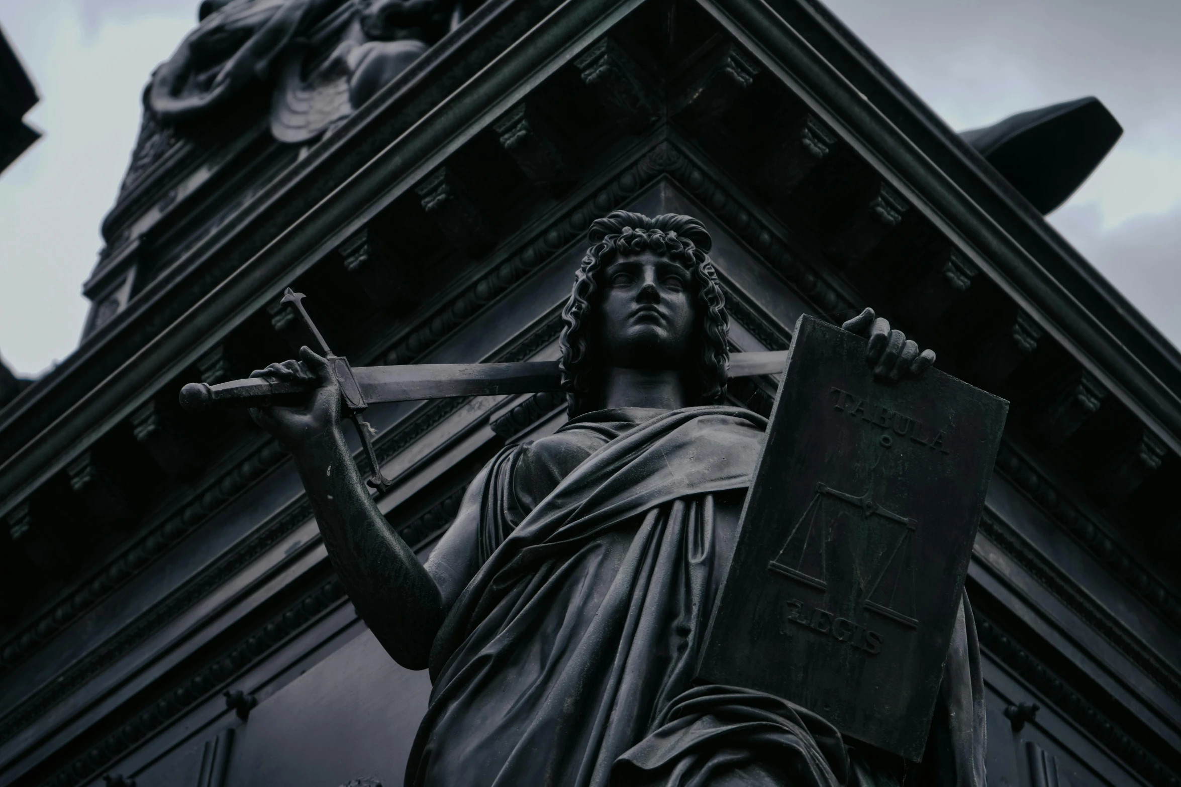 a statue in a cathedral that has a religious cross on the cross