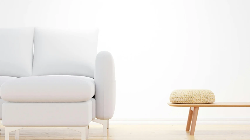 a white couch and coffee table on the wood floor