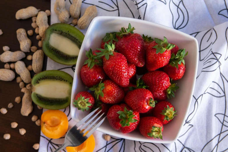 fresh strawberries in a bowl with other fruits and vegetables